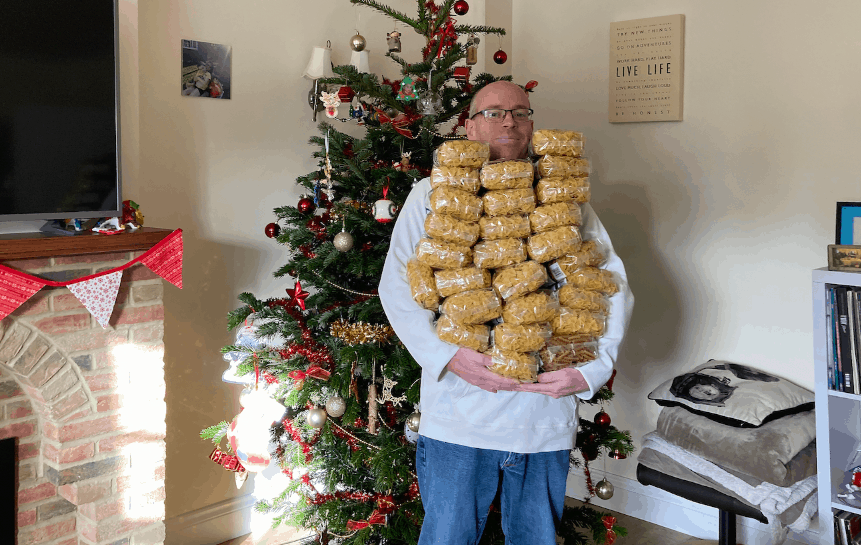 Ben Taylor carrying bags of pasta