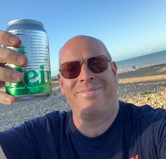 On the beach drinking beer.