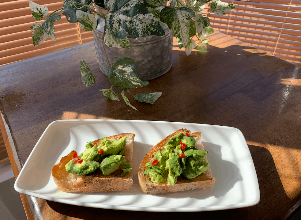 Avocado on toast at a sunny table