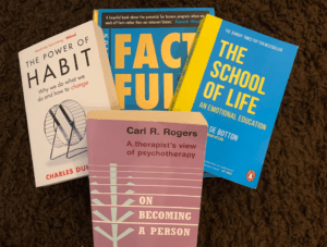 Life changing self help books that actually work - in a pile