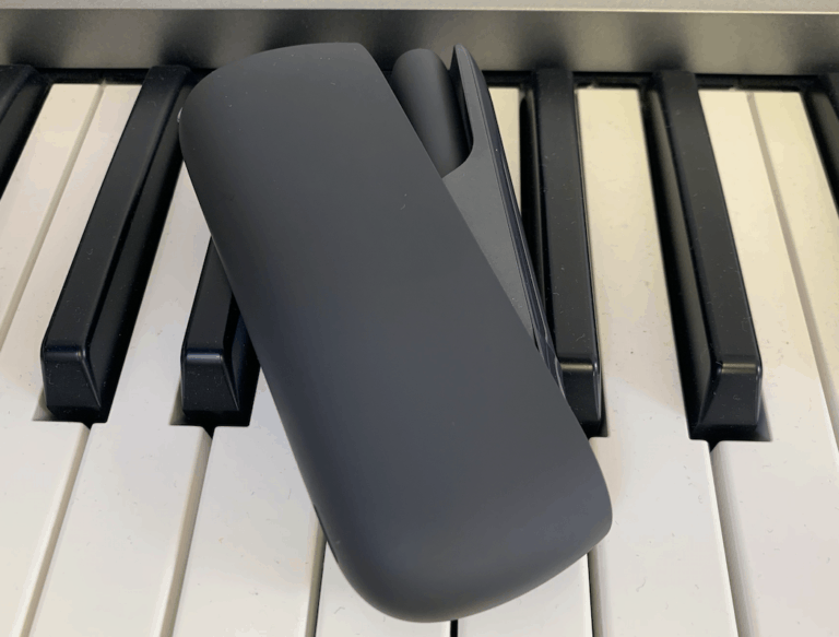 IQOS device on piano